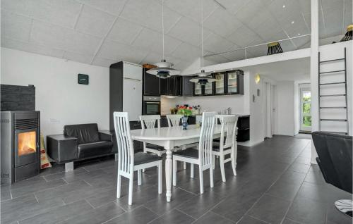 a kitchen and dining room with a white table and chairs at Beautiful Home In Børkop With Kitchen in Børkop