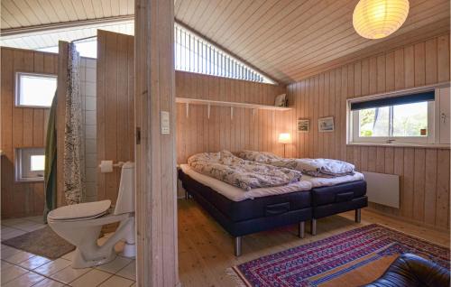 エーベルトフトにある4 Bedroom Beach Front Home In Ebeltoftの木製の部屋にベッド1台が備わるベッドルーム1室があります。