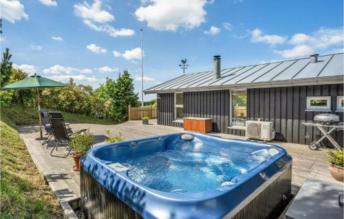 a hot tub on a deck with a house at Two-Bedroom Holiday Home In Ebeltoft in Ebeltoft