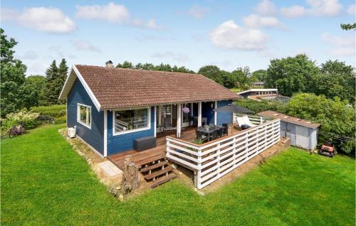 an overhead view of a blue house with a deck at Holiday Home Hejls 28 in Hejls