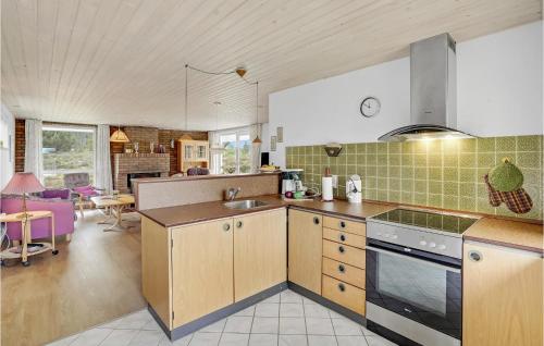a kitchen with a sink and a stove top oven at 3 Bedroom Nice Home In Rømø in Tagholm
