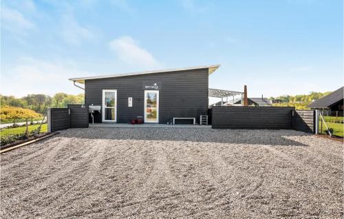 a house with a gravel driveway in front of it at Four-Bedroom Holiday Home In Haderslev in Haderslev