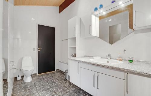 a white bathroom with a sink and a toilet at Cozy Home In Hvide Sande With House Sea View in Hvide Sande