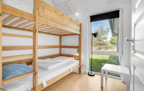 ロモ・キルケビーにあるBeautiful Home In Rm With 9 Bedrooms, Sauna And Private Swimming Poolの二段ベッド2台と窓が備わる客室です。