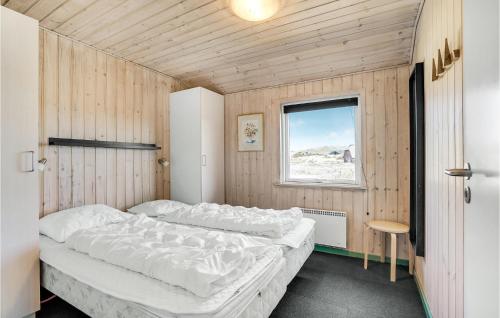 HavrvigにあるStunning Home In Hvide Sande With 4 Bedrooms, Sauna And Wifiのベッドルーム1室(ベッド2台、窓付)