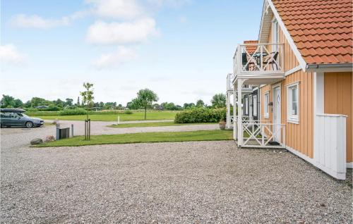 a building with a driveway next to a parking lot at Gorgeous Home In Brenderup Fyn in Bro