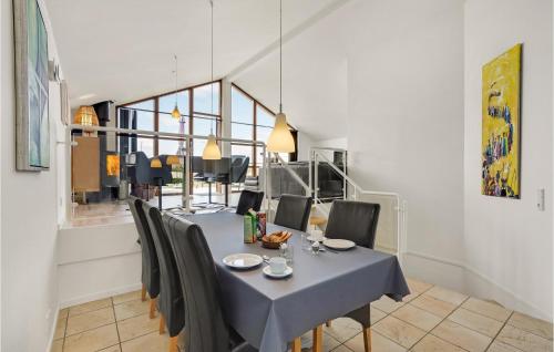 a dining room with a blue table and chairs at Amazing Home In Egernsund With Sauna in Egernsund