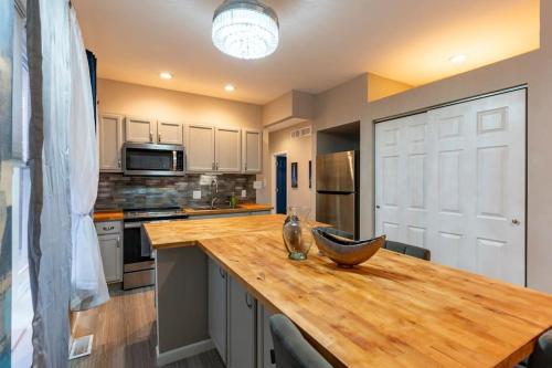 a kitchen with a wooden counter top with a bowl on it at Pretty Blue Bungalow in Carondelet