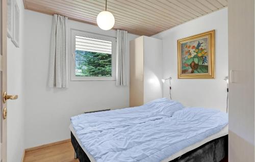 a bedroom with a bed and a window at Holiday Home Rønnebærvænget Hejls V in Hejls