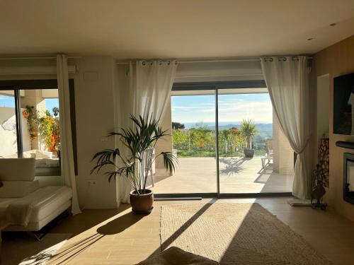 a living room with a large sliding glass door at Casa Carolina - This One in Higuerón with Quality and Peace in Mijas
