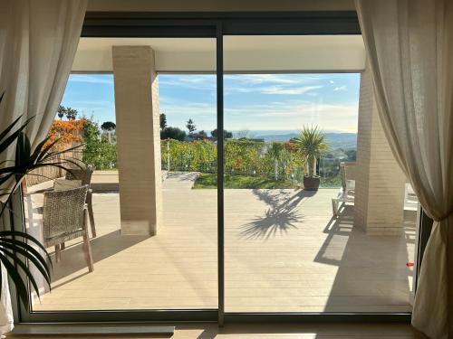 a view of a patio from a house with sliding glass doors at Casa Carolina - This One in Higuerón with Quality and Peace in Mijas