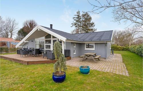 a small grey house with a deck and a patio at Lovely Home In Kerteminde With Wifi in Kerteminde