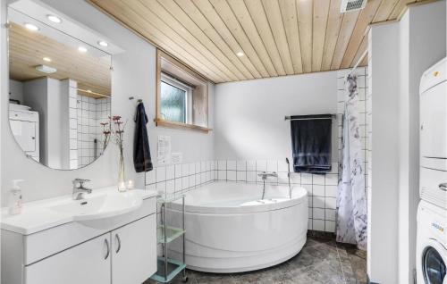 a bathroom with a tub and a sink at Awesome Home In Hasle With Harbor View in Hasle