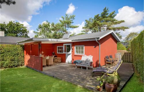 a red tiny house with a deck at Holiday Home Midtvej Nexø V in Neksø