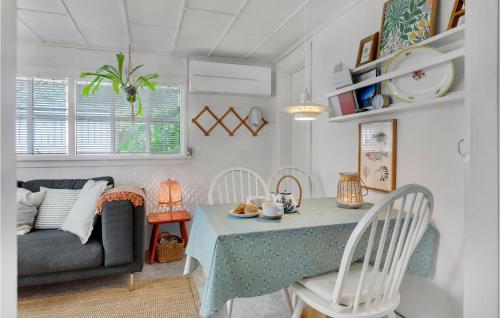 a living room with a table and a couch at Holiday Home Midtvej Nexø V in Neksø