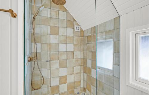 a bathroom with a shower with a glass door at Holiday Home Sydslugen Blåvand Ii in Blåvand