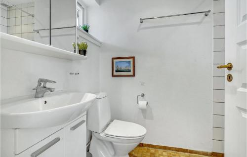 a white bathroom with a sink and a toilet at Cozy Apartment In Borre With House Sea View in Borre