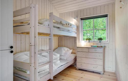 a bedroom with two bunk beds and a window at Beach Front Home In Stege With Wifi in Stege