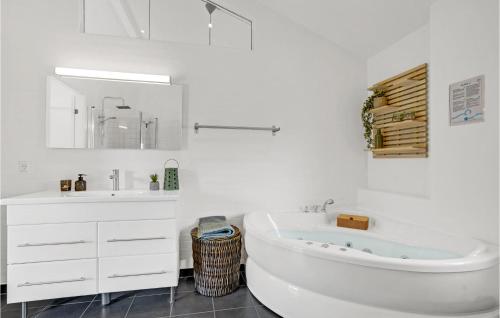 a white bathroom with a tub and a sink at 4 Bedroom Stunning Home In Skjern in Lem