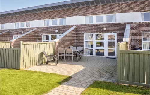 a patio with a table and chairs in front of a building at Nice Home In Hemmet With Kitchen in Hemmet