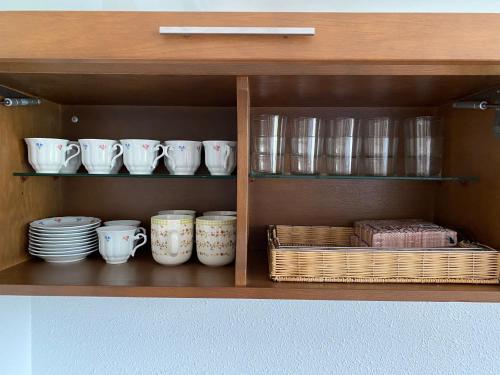 a cabinet with plates and cups and bowls and baskets at ARTZA ETXIE LA CASA EBI01934 in Bermeo