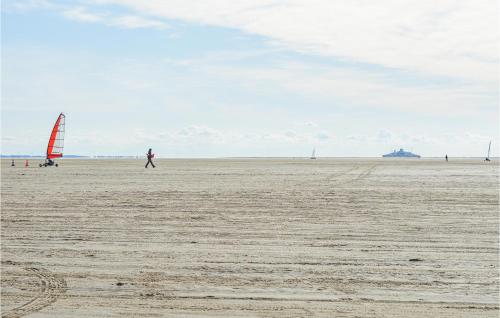 a person walking on the beach with a sail at 3 Bedroom Lovely Home In Rømø in Havneby