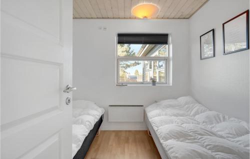 a room with white walls and a window and beds at Holiday Home Pengeurtvej Vordingborg V in Vordingborg