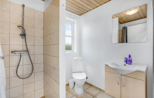 a bathroom with a shower and a toilet and a sink at Stunning Home In Idestrup With Indoor Swimming Pool in Marielyst