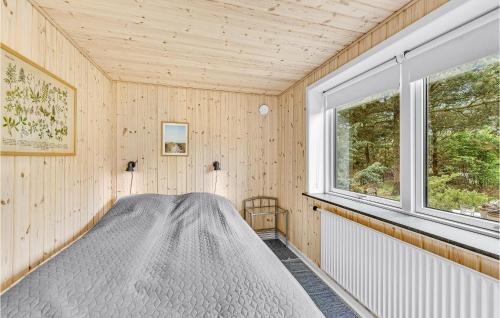 a bedroom with a bed in a room with a window at Nice Home In Tarm With Wifi in Tarm