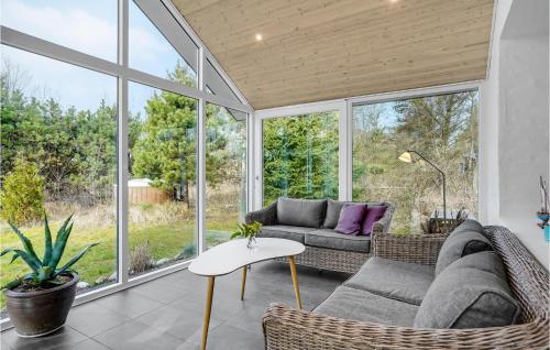 a screened in porch with a couch and a table at Nice Home In Tarm With Wifi in Tarm