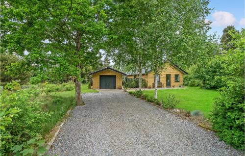 a driveway leading to a house with a garage at Nice Home In Tarm With Wifi in Tarm