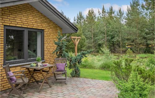 a patio with a table and chairs in front of a house at Nice Home In Tarm With Wifi in Tarm
