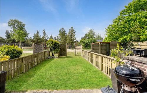 a garden with a wooden fence and grass at 2 Bedroom Lovely Home In Rømø in Rømø Kirkeby