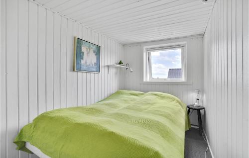 a bedroom with a green bed with a window at 3 Bedroom Awesome Home In Hejls in Hejls