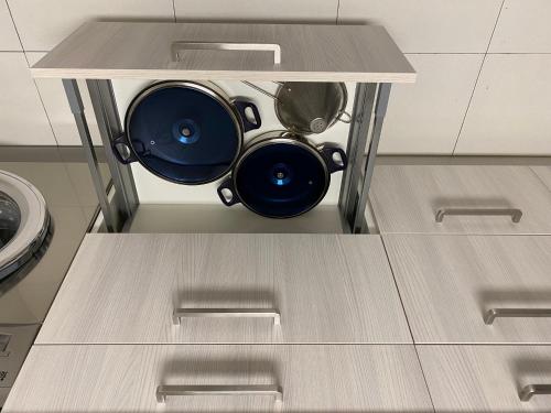 a shelf with two pots and pans on it in a kitchen at ARTZA ETXIE LA CASA EBI01934 in Bermeo