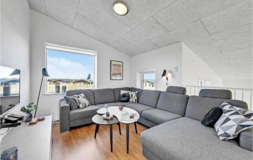a living room with a couch and a table at Holiday Home Ringkøbing 3 in Søndervig