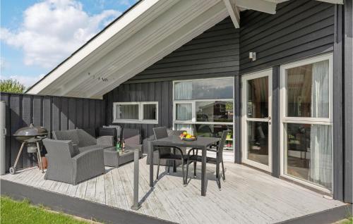 a wooden deck with chairs and a table on a house at Holiday Home Solbjergvej Sydals Denm in Høruphav