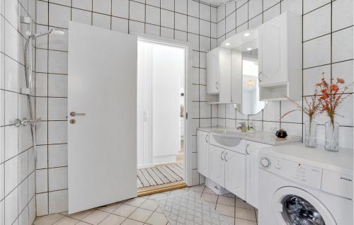 a white bathroom with a sink and a washing machine at Holiday Home Hermodsvej Harboøre Xi in Harboør