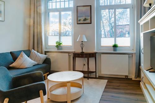 a living room with a couch and a table at Ferienwohnungen Am Kirchenplatz in Warnemünde