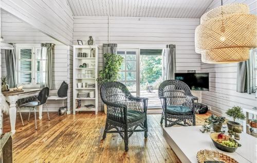 a living room with wicker chairs and a table at Two-Bedroom Holiday Home In Krusa in Kruså