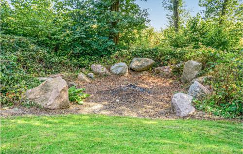 a pile of rocks sitting on the grass at Two-Bedroom Holiday Home In Krusa in Kruså