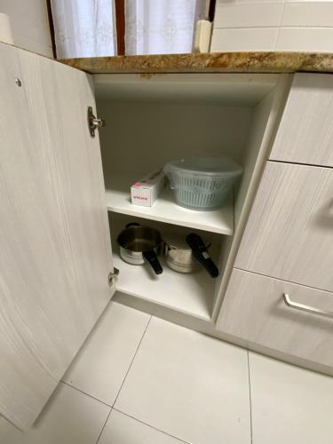 a kitchen cabinet with a cupboard with a bowl at ARTZA ETXIE LA CASA EBI01934 in Bermeo