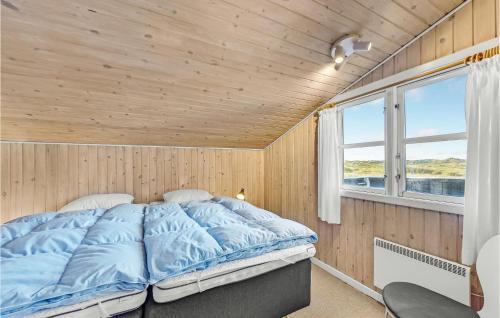 a bed in a room with a wooden ceiling at 3 Bedroom Amazing Home In Rm in Bolilmark