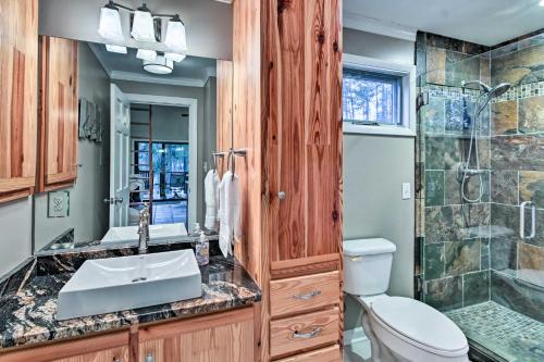 a bathroom with a sink and a toilet and a shower at Rockingham Cabin on 75 Acres with Lake Access! in Rockingham
