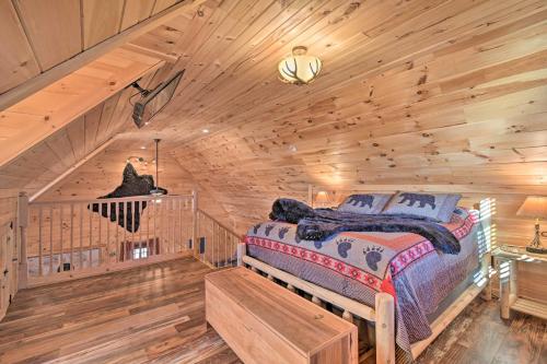 a bedroom with a bed in a log cabin at Quiet and Secluded Berea Cabin on 70-Acre Farm! in Berea