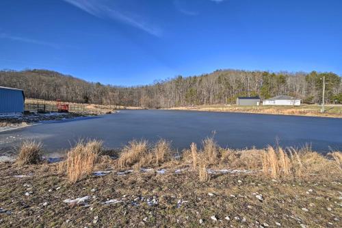 an empty lake in the middle of a field at Quiet and Secluded Berea Cabin on 70-Acre Farm! in Berea