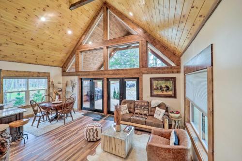 a living room with a couch and a table at Fire Pit and Grill Modern Beech Mountain Cabin! in Beech Mountain