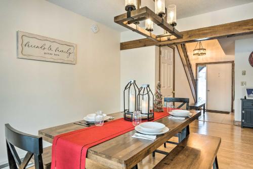 a dining room with a wooden table with a red table cloth at Hartford Escape with Fire Pit about 3 Mi to Ski and Golf! in Hartford
