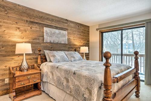 a bedroom with a bed and a wooden wall at Hartford Escape with Fire Pit about 3 Mi to Ski and Golf! in Hartford