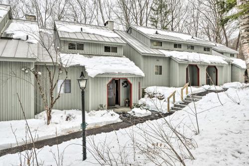 a house is covered in snow with a street light at Hartford Escape with Fire Pit about 3 Mi to Ski and Golf! in Hartford